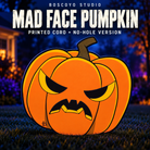 DayCorO HiRes Pumpkin 4 Mad Face, the flat printed no-hole version in orange with black and yellow face, on a dark blue evening yard background.
