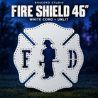 Boscoyo Fire Shield 46-inch white coro prop with empty pixel holes and firefighter, F and D cutouts, unlit on a dark blue evening yard.